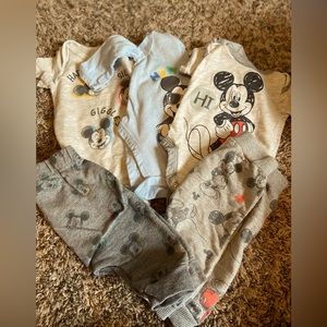 Multiple Mickey Mouse baby boy clothes.